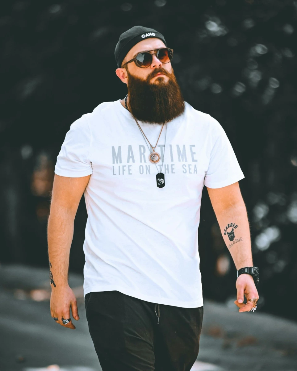 a man with a beard wearing a white shirt